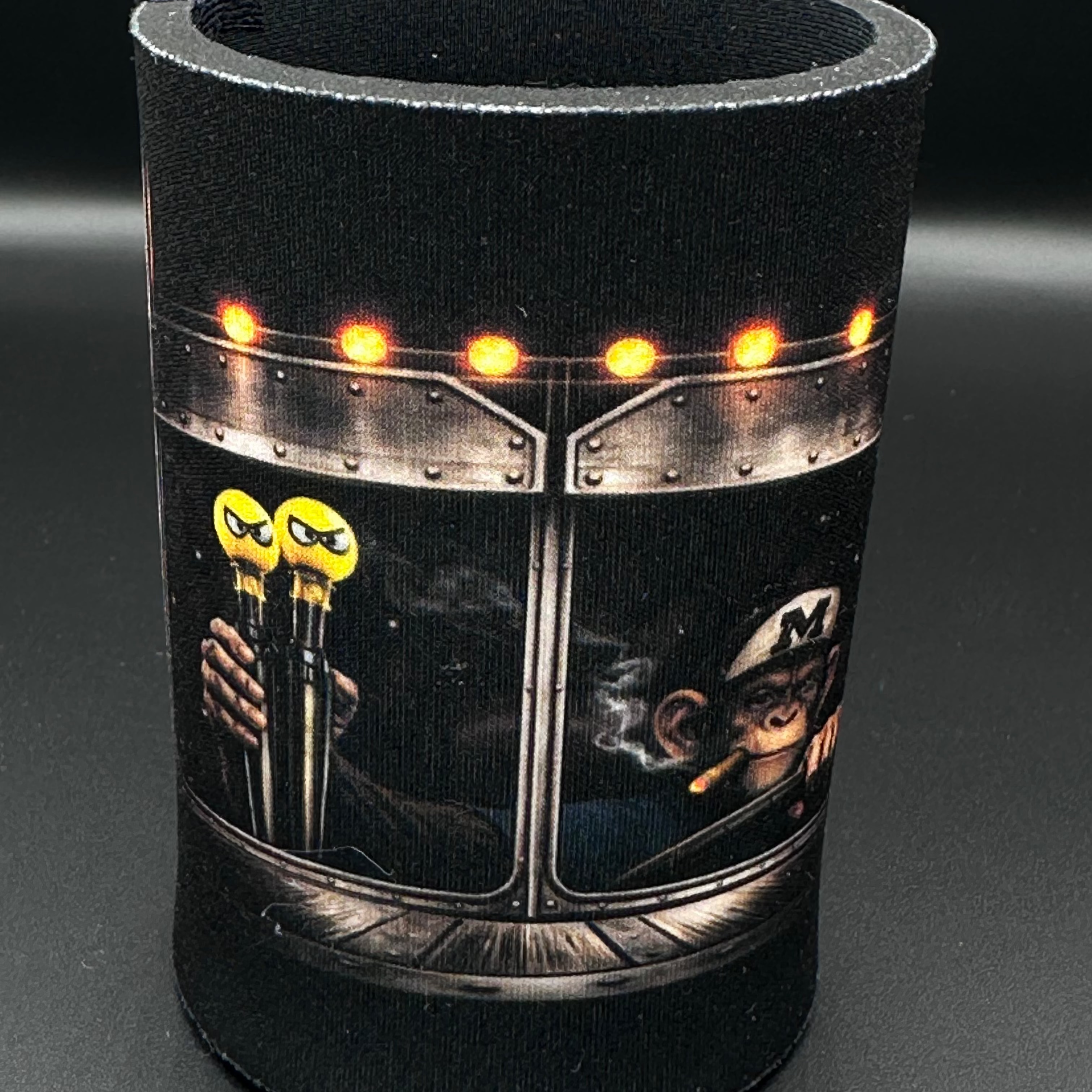 Black can cooler with graphic design on a dark background