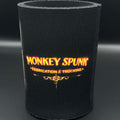 A black neoprene can cooler sleeve featuring the text 'MONKEY SPUNK FABRICATION & TRUCKING' in orange and yellow lettering, set against a dark gray background.